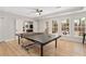 Bright game room featuring a ping pong table, many windows, and backyard views at 8643 Ellard Dr, Alpharetta, GA 30022