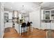 Bright kitchen featuring island seating, stainless steel appliances and custom cabinetry at 8643 Ellard Dr, Alpharetta, GA 30022