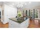 An open kitchen with a large island, granite countertops, and stainless steel appliances at 8643 Ellard Dr, Alpharetta, GA 30022