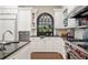 A spacious kitchen with white cabinetry, stainless steel appliances, and granite countertops at 8643 Ellard Dr, Alpharetta, GA 30022