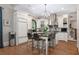 Elegant kitchen with island seating, stainless hood, and custom cabinets at 8643 Ellard Dr, Alpharetta, GA 30022