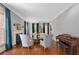 Elegant living room boasts hardwood floors, a fireplace, and ample natural light from large windows with stylish decor at 8643 Ellard Dr, Alpharetta, GA 30022