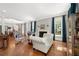 Bright and airy living room featuring hardwood floors, a fireplace, and large windows with elegant furnishings at 8643 Ellard Dr, Alpharetta, GA 30022
