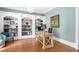 Charming office featuring custom built-in bookshelves, hardwood flooring and serene decor at 8643 Ellard Dr, Alpharetta, GA 30022