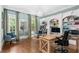 Lovely office space with bookshelves, chandelier, hardwood flooring and natural lighting at 8643 Ellard Dr, Alpharetta, GA 30022