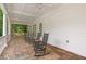 Covered porch with ceiling fans and rocking chairs, perfect for relaxing and enjoying the outdoors at 8643 Ellard Dr, Alpharetta, GA 30022