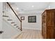 Elegant staircase with wooden banister, leading to a lower level or basement area at 8643 Ellard Dr, Alpharetta, GA 30022