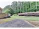 View of the backyard featuring green grass, nice landscaping, and tall trees at 1102 Lexington Dr, Roswell, GA 30075
