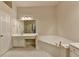 Bathroom featuring a soaking tub, double sink vanity, and tile flooring at 1102 Lexington Dr, Roswell, GA 30075