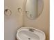 Close-up of bathroom sink with an oval mirror and classic gold and silver fixtures at 1102 Lexington Dr, Roswell, GA 30075
