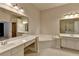Bathroom featuring a soaking tub, double sink vanity, and tile flooring at 1102 Lexington Dr, Roswell, GA 30075