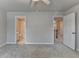 The carpeted bedroom features a ceiling fan and access to an ensuite bathroom and the hallway at 1102 Lexington Dr, Roswell, GA 30075