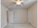 The bedroom includes neutral carpet and paint, featuring a ceiling fan and two doors at 1102 Lexington Dr, Roswell, GA 30075
