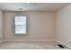 A bright bedroom features a neutral carpet, ceiling fan, window with blinds, and neutral wall paint at 1102 Lexington Dr, Roswell, GA 30075