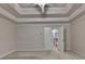 Spacious bedroom with a tray ceiling and access to another room at 1102 Lexington Dr, Roswell, GA 30075