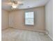 The bedroom has neutral carpet and paint, featuring a ceiling fan and a window with blinds at 1102 Lexington Dr, Roswell, GA 30075