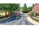 The entrance to a community featuring an iron gate and brick pillars at 1102 Lexington Dr, Roswell, GA 30075