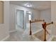 Upstairs hallway showcasing wood and white railing and neutral carpet at 1102 Lexington Dr, Roswell, GA 30075
