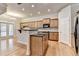 Open kitchen features ample cabinetry, a center island, stainless steel appliances, and an adjoining breakfast area at 1102 Lexington Dr, Roswell, GA 30075