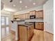 Modern kitchen features wooden cabinets, stainless appliances, a center island with bar and granite countertops at 1102 Lexington Dr, Roswell, GA 30075