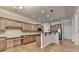 The open kitchen features an island, stainless steel appliances, granite counters and plentiful cabinet space at 1102 Lexington Dr, Roswell, GA 30075