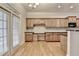 Spacious kitchen features custom cabinetry, granite countertops, hardwood floors and stainless steel appliances at 1102 Lexington Dr, Roswell, GA 30075