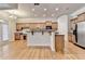 Stylish kitchen featuring granite countertops, stainless appliances, wooden cabinetry, an island, and breakfast bar at 1102 Lexington Dr, Roswell, GA 30075