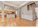 Bright, open-concept living room featuring hardwood floors, a staircase, and a view of the kitchen with a breakfast bar at 1102 Lexington Dr, Roswell, GA 30075