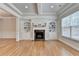 Inviting living room with a fireplace, built-in bookshelves, and hardwood floors at 1102 Lexington Dr, Roswell, GA 30075
