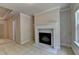 Cozy living room featuring a fireplace with marble surround and a tray ceiling at 1102 Lexington Dr, Roswell, GA 30075