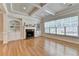 Elegant living room with coffered ceilings, a fireplace, built-in shelving, and a large window for natural light at 1102 Lexington Dr, Roswell, GA 30075