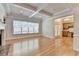 Inviting living room with coffered ceilings, hardwood floors, and a large window for natural light at 1102 Lexington Dr, Roswell, GA 30075