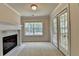 Cozy living room featuring a fireplace with marble surround and a sliding glass door at 1102 Lexington Dr, Roswell, GA 30075