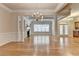 Bright living room with hardwood floors, a fireplace, and elegant chandelier at 1102 Lexington Dr, Roswell, GA 30075