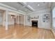 Spacious living area with coffered ceilings, hardwood floors, fireplace and built-in shelving at 1102 Lexington Dr, Roswell, GA 30075