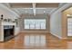 Cozy living room with a marble fireplace, built-in bookshelves, hardwood floors, and plenty of natural light at 1102 Lexington Dr, Roswell, GA 30075