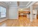 Bright and airy living room with hardwood floors, coffered ceilings, and access to the kitchen at 1102 Lexington Dr, Roswell, GA 30075