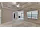 Light-filled primary bedroom boasts a tray ceiling, fireplace, and a sitting area at 1102 Lexington Dr, Roswell, GA 30075