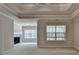 Spacious main bedroom featuring a tray ceiling, fireplace, and large windows at 1102 Lexington Dr, Roswell, GA 30075