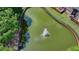 Aerial view of pond with fountain and manicured lawn at 1102 Lexington Dr, Roswell, GA 30075
