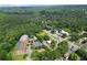 An aerial view of a brick apartment complex showing the tennis court, pool, and surrounding green spaces at 3330 Overland Dr, Roswell, GA 30075