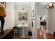 Elegant powder room with decorative mirror and stylish pedestal sink at 3330 Overland Dr, Roswell, GA 30075