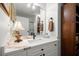 Bright bathroom featuring white cabinets, sleek fixtures, marble countertop, and a modern lamp at 3330 Overland Dr, Roswell, GA 30075