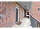 Inviting condo entrance featuring a brick exterior, black door, and covered walkway at 3330 Overland Dr, Roswell, GA 30075