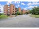 A low-rise brick apartment building with balconies and well-kept grounds, offering a pleasant living environment at 3330 Overland Dr, Roswell, GA 30075