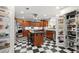 Kitchen area featuring a chef's kitchen with stainless steel appliances, a pantry, and black and white checkered flooring at 3330 Overland Dr, Roswell, GA 30075