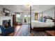 Bright main bedroom with a fireplace, sitting area, and access to a balcony at 3330 Overland Dr, Roswell, GA 30075
