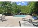 Inviting community pool surrounded by lounge chairs and lush greenery offers a relaxing escape at 3330 Overland Dr, Roswell, GA 30075