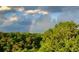 A rainbow behind a tree line at 3330 Overland Dr, Roswell, GA 30075