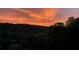 A colorful sunrise over a dark tree line at 3330 Overland Dr, Roswell, GA 30075